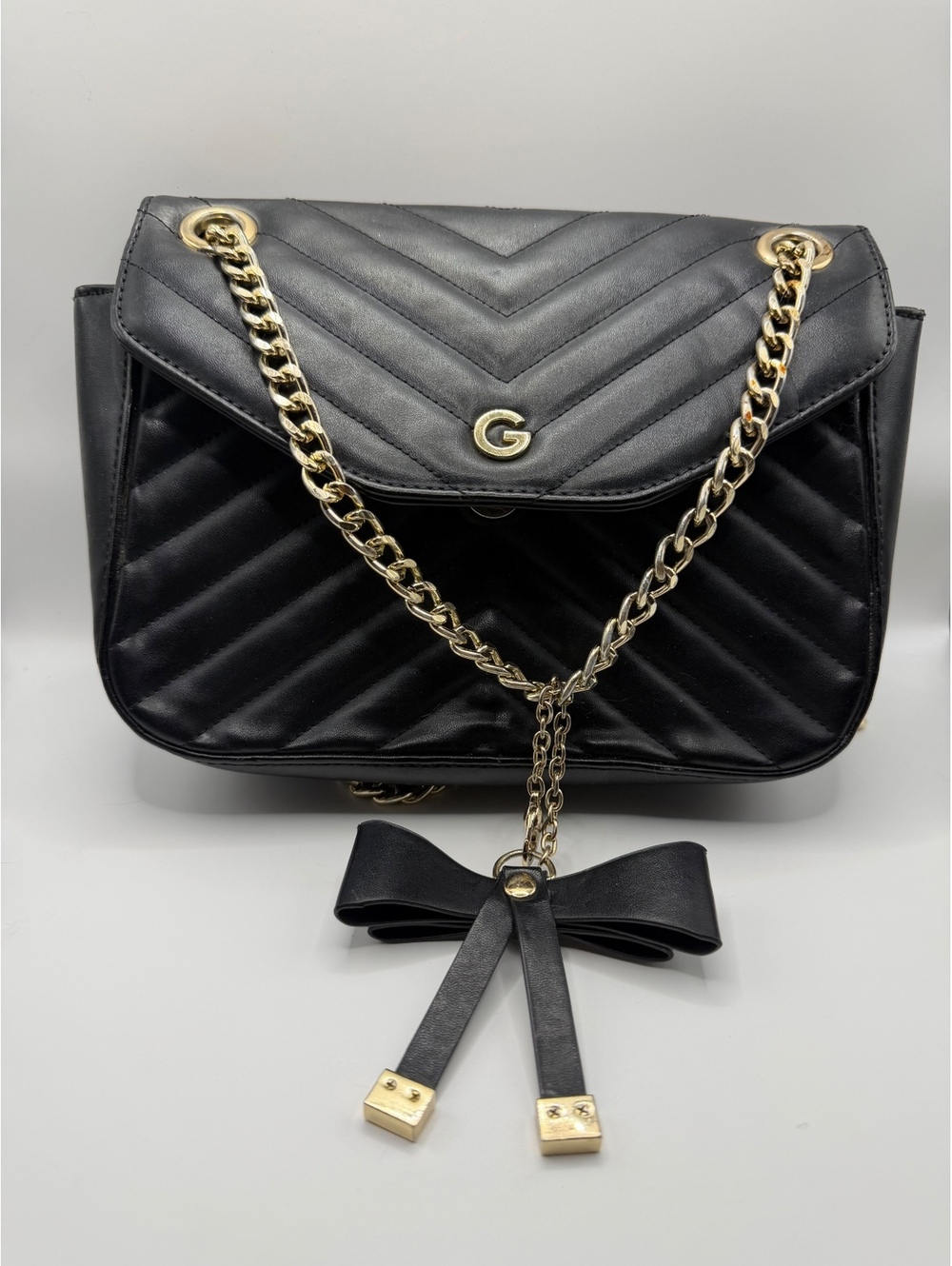 Black Quilted Crossbody Bag with Gold Chain and Bow Accent